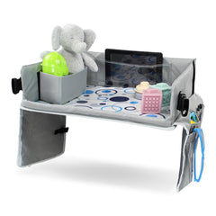 Acorn Baby foldable backseat tray table close-up shows organized storage for toys and snacks.