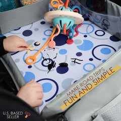 Acorn Baby foldable tray folded for storage shows compact design under seat or in a door.