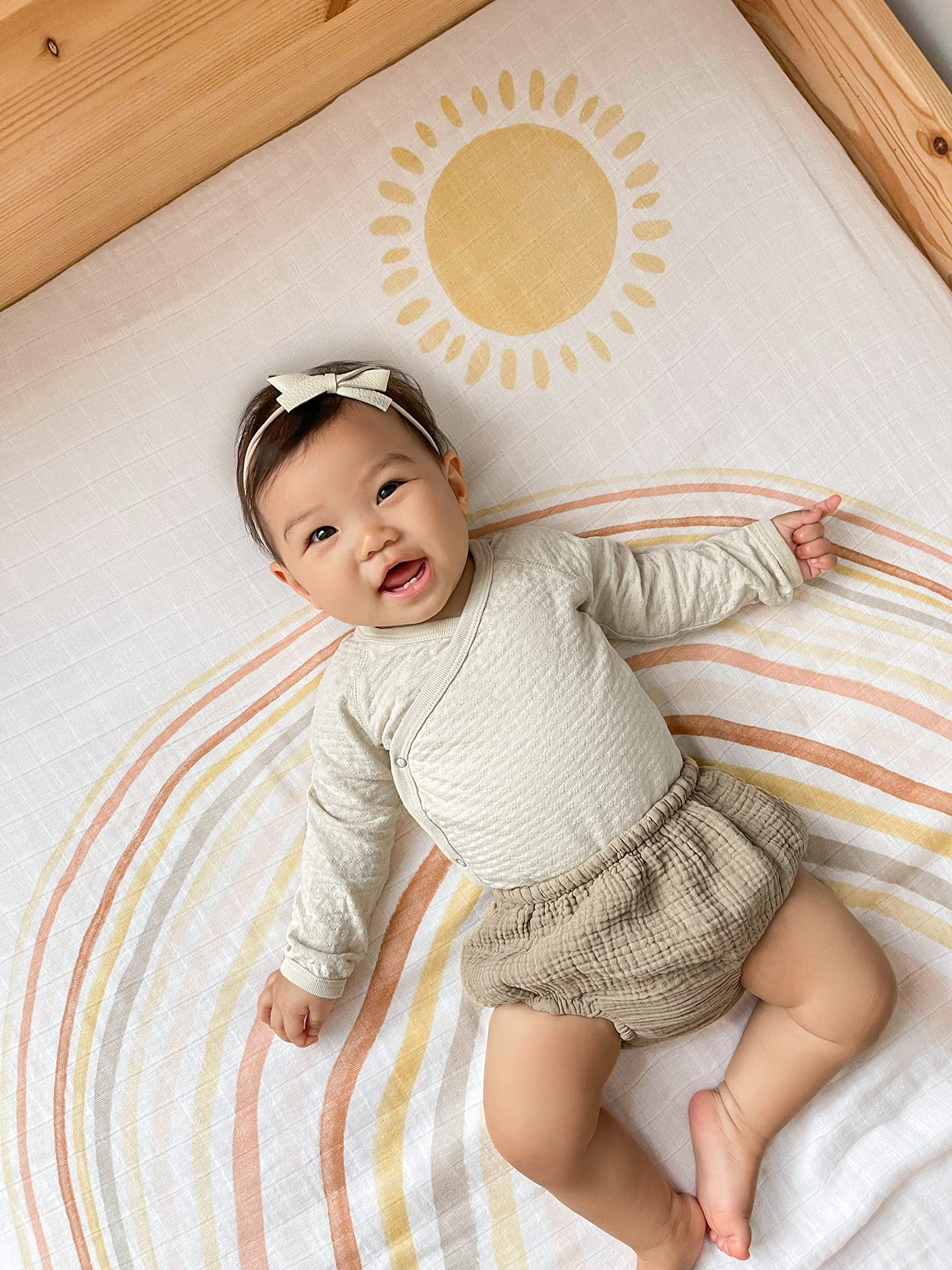 aden + anais swaddle being used as a stroller cover in sunny day setting.