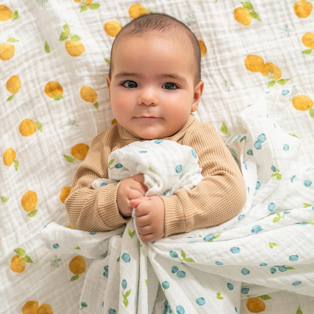 aden + anais Boutique Organic Swaddle Blanket demonstrates a 47x47 inch size for versatile swaddling.