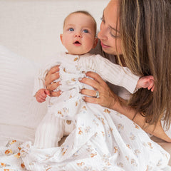 aden + anais Disney muslin swaddle blanket used as a receiving blanket during diaper changes.