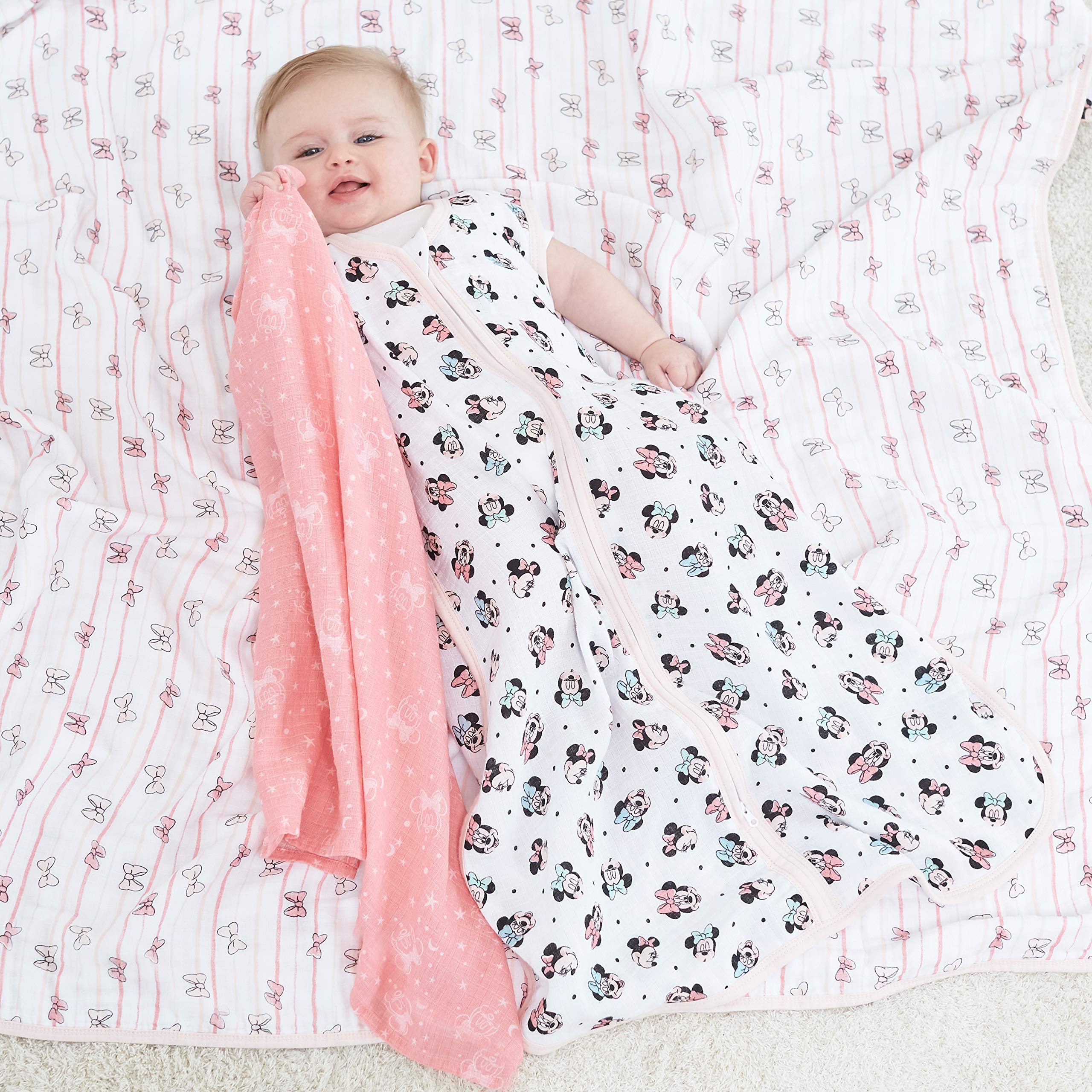 aden + anais Minnie Rainbows Dream Blanket bedtime-snuggle image emphasizes soft, breathable fabric for night-time rest.