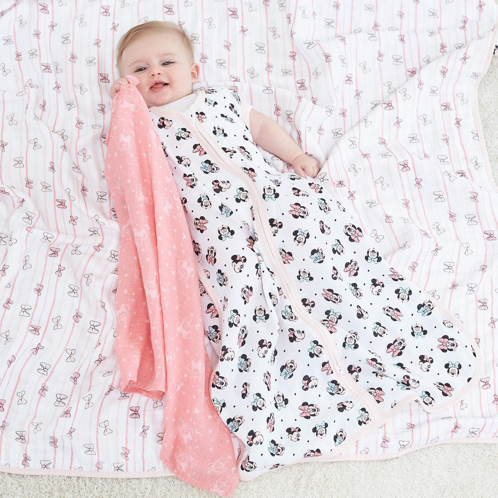 aden + anais Minnie Rainbows Dream Blanket bedtime-snuggle image emphasizes soft, breathable fabric for night-time rest.