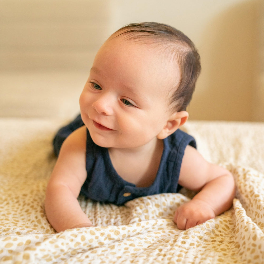 aden + anais dream blanket on crib demonstrates versatile size for naps.