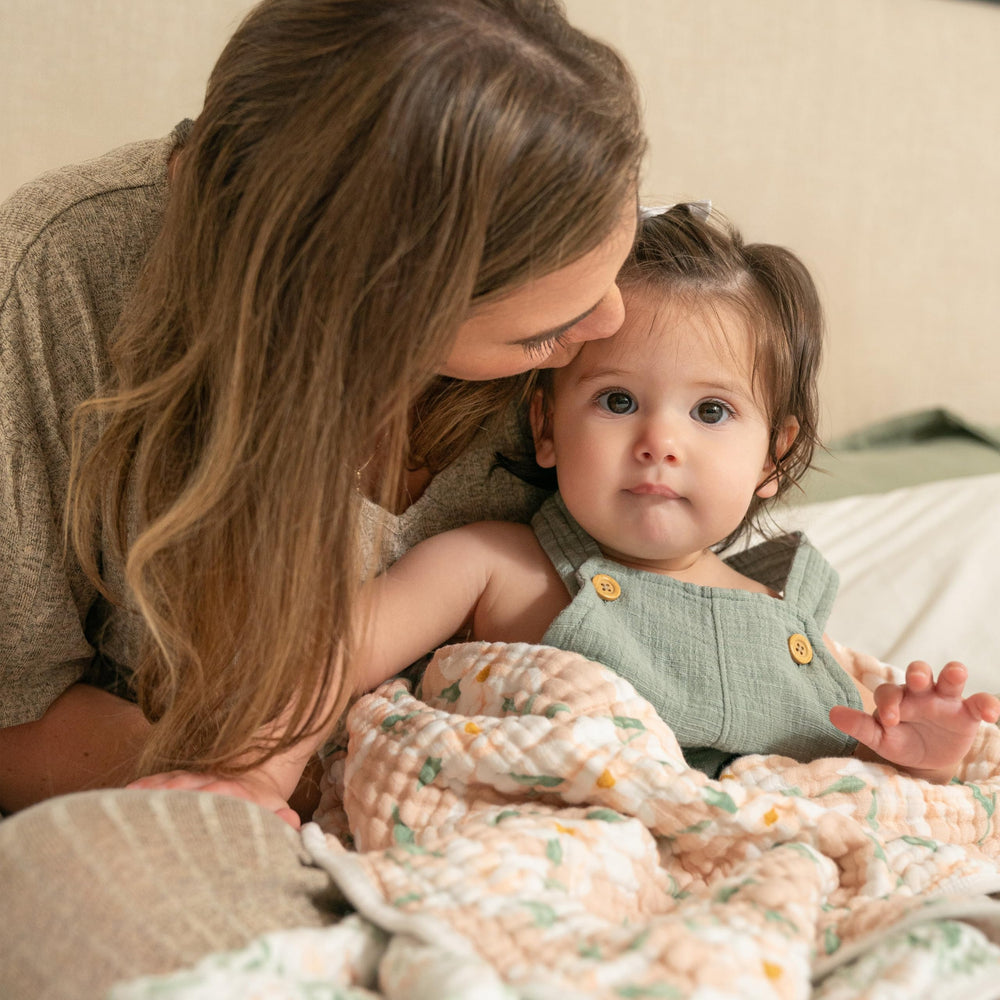 aden + anais Dream Blanket cuddled during playtime for cozy moments.