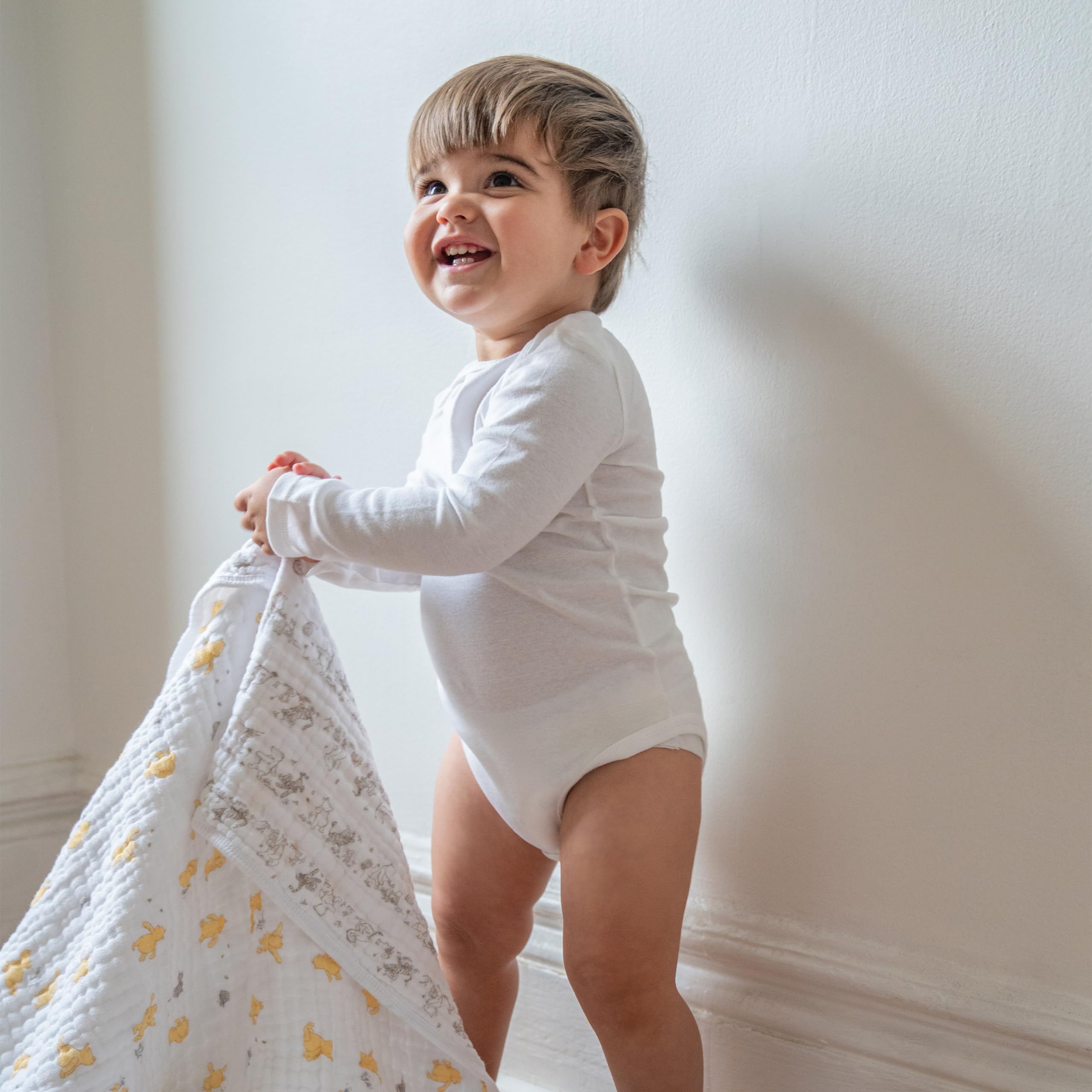 aden + anais Dream Blanket Winnie Pooh muslin closeup shows soft, durable fabric.