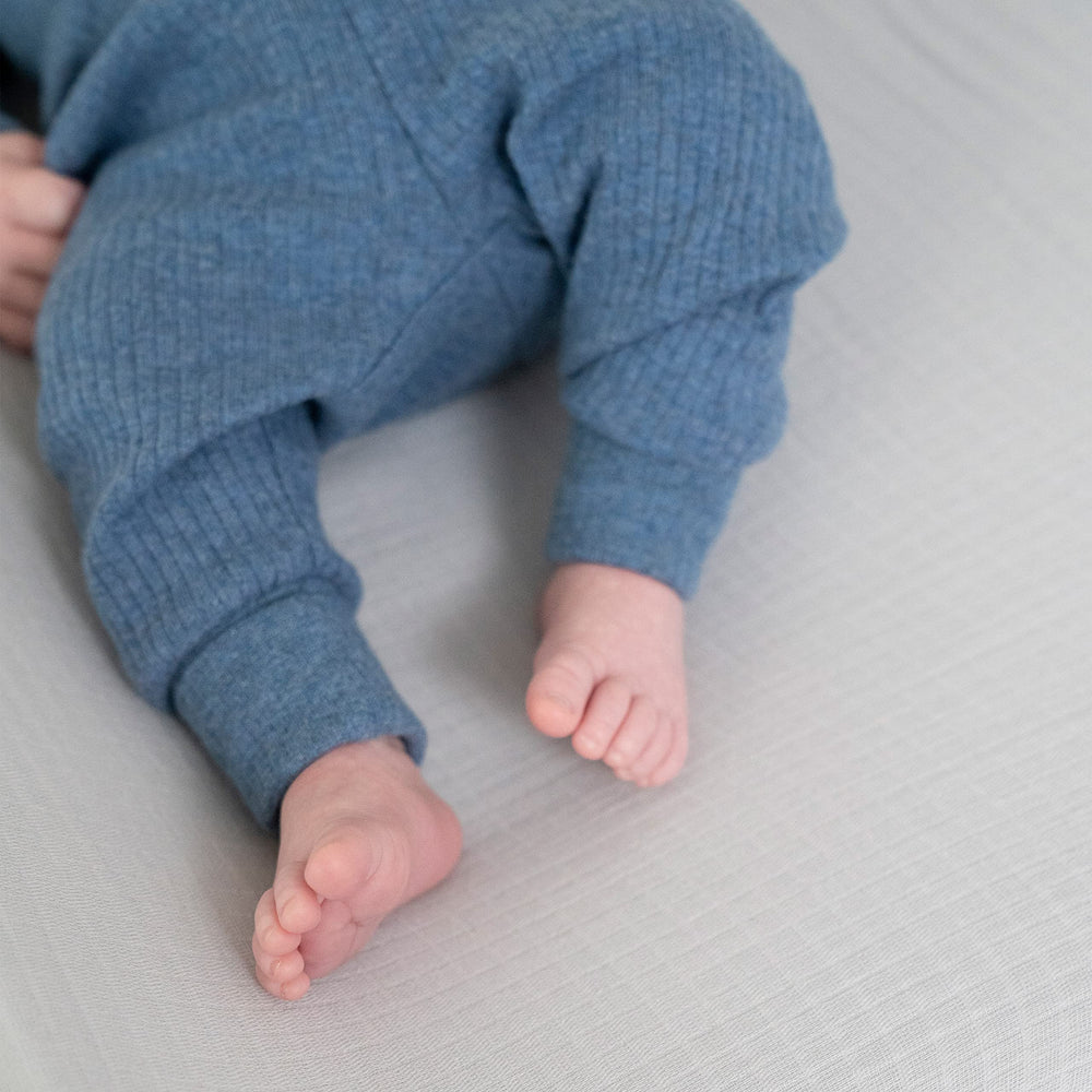 aden + anais essentials changing pad cover shows strap-slot openings for safety restraints