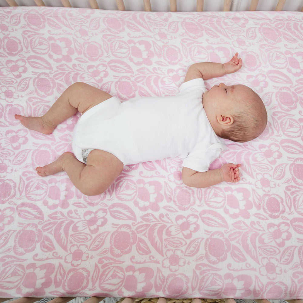 Nursery scene with aden + anais crib sheet, showcasing versatile style and decor compatibility