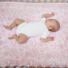 Nursery scene with aden + anais crib sheet, showcasing versatile style and decor compatibility