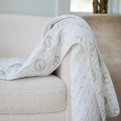 aden + anais Essentials Dream Blanket on the crib for versatile warmth and security.