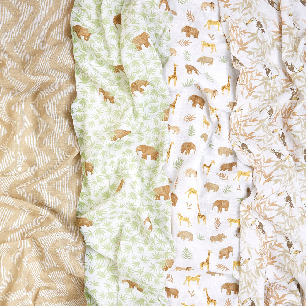 aden + anais Essentials swaddle blankets in use around a baby for snug, breathable comfort.