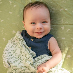aden + anais Nature Friends swaddle wrapped baby showing cozy newborn wrap.