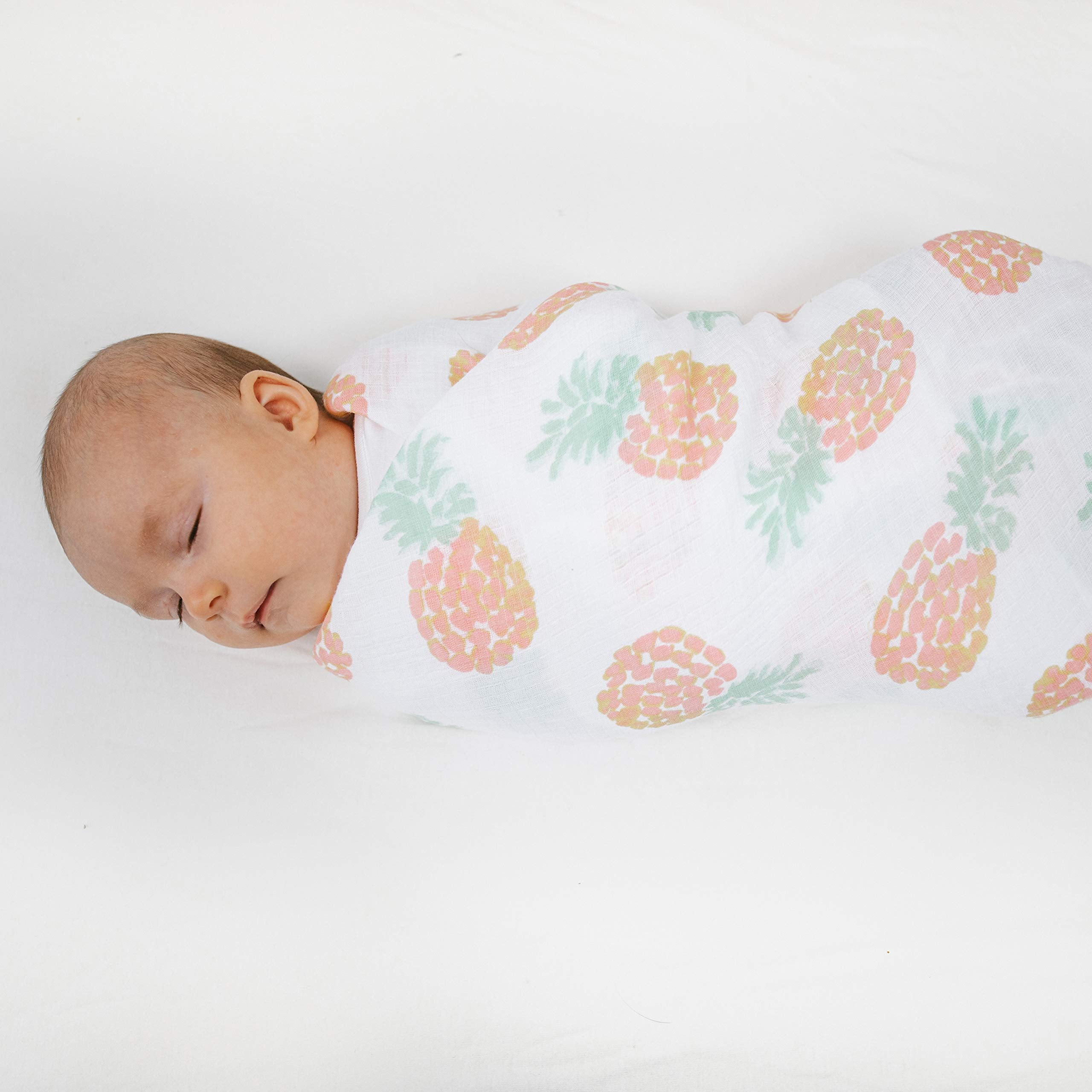aden + anais Essentials Swaddle Tropicalia blanket on a tummy time mat