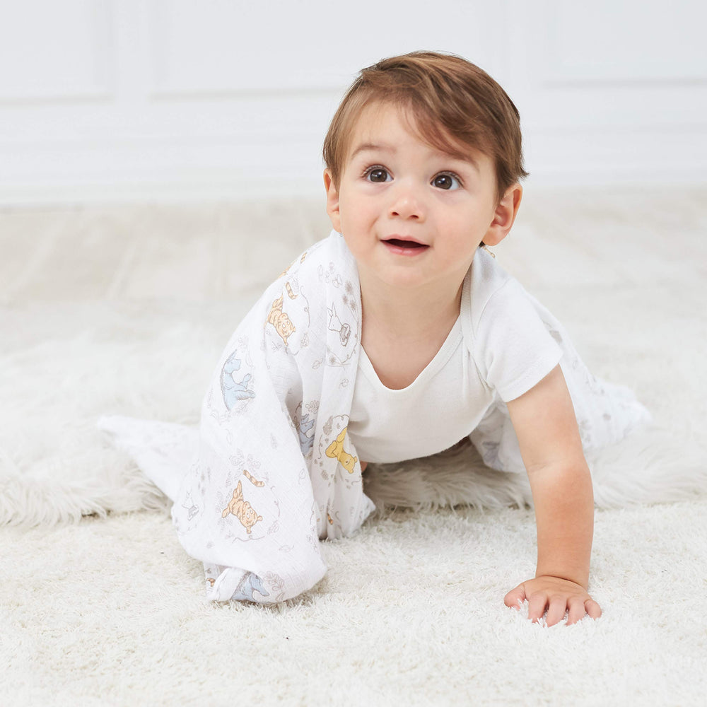 aden + anais Winnie + Friends swaddle blanket used as tummy time mat for gentle play
