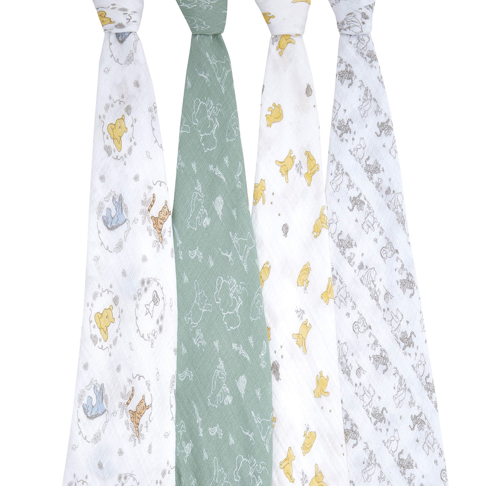 aden + anais Winnie + Friends swaddle blanket worn by baby for secure comfort during cuddles
