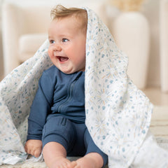aden +anais Harmony receiving blanket in use as a cozy stroller cover or nursing aid.