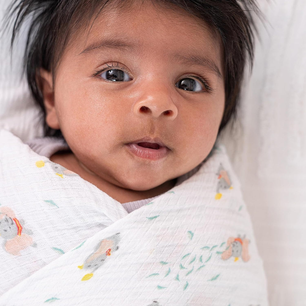 aden + anais swaddle wrap shown wrapping baby for snug, secure comfort