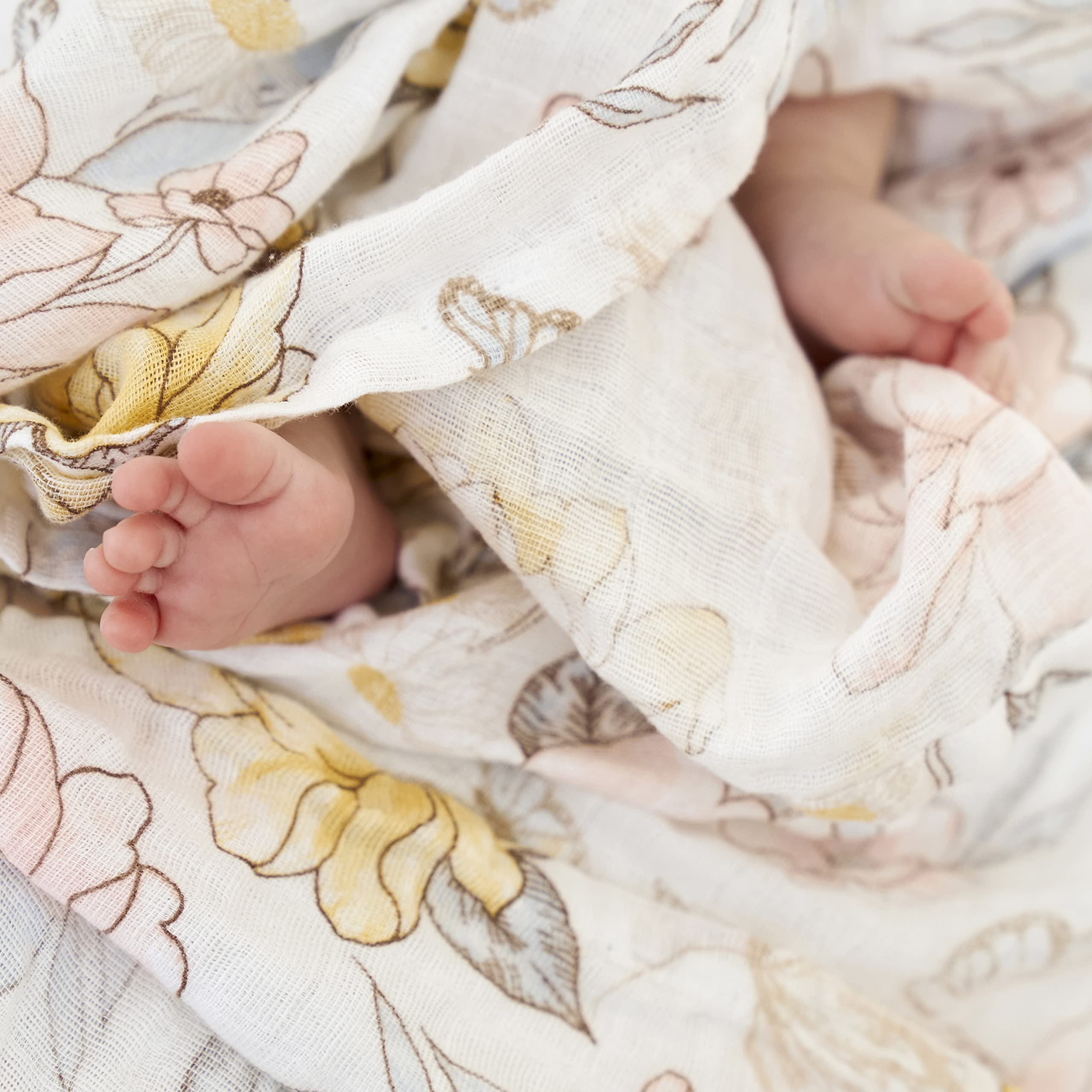 aden + anais Earthly swaddle blanket scene shows stroller cover versatility for on-the-go protection.