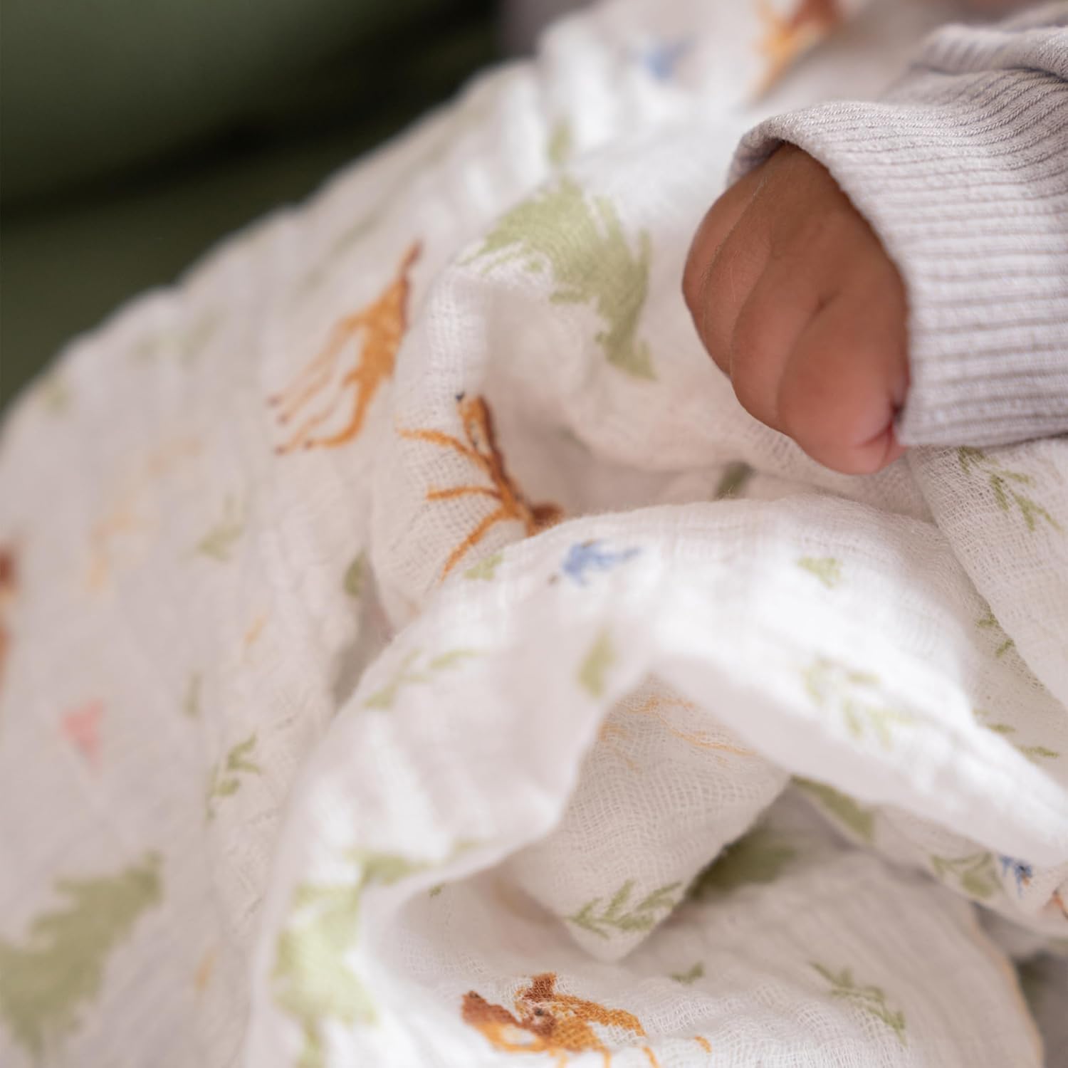 aden + anais swaddle used as stroller cover to shade and protect baby