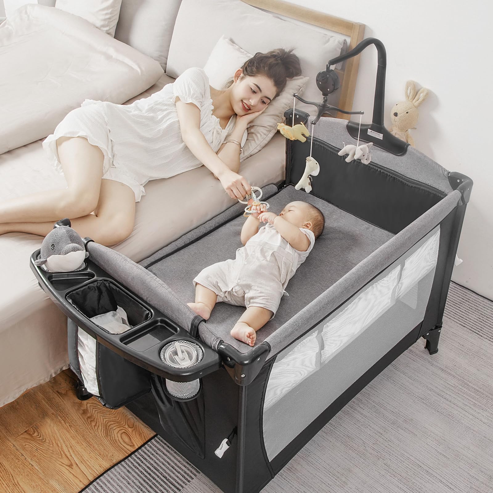 Afgbf 5-in-1 pack and play bedside sleeper in use for nighttime soothing.