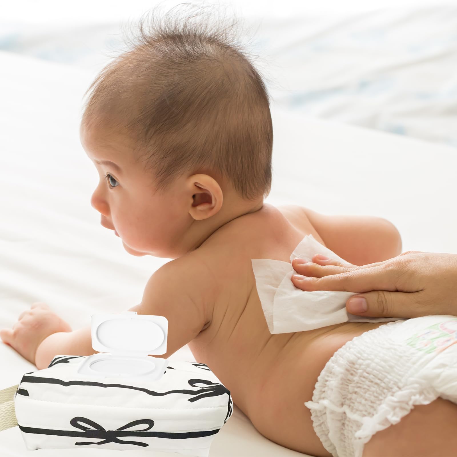 AGLOO Bow Wipes Holder hangs on stroller for hands-free access.