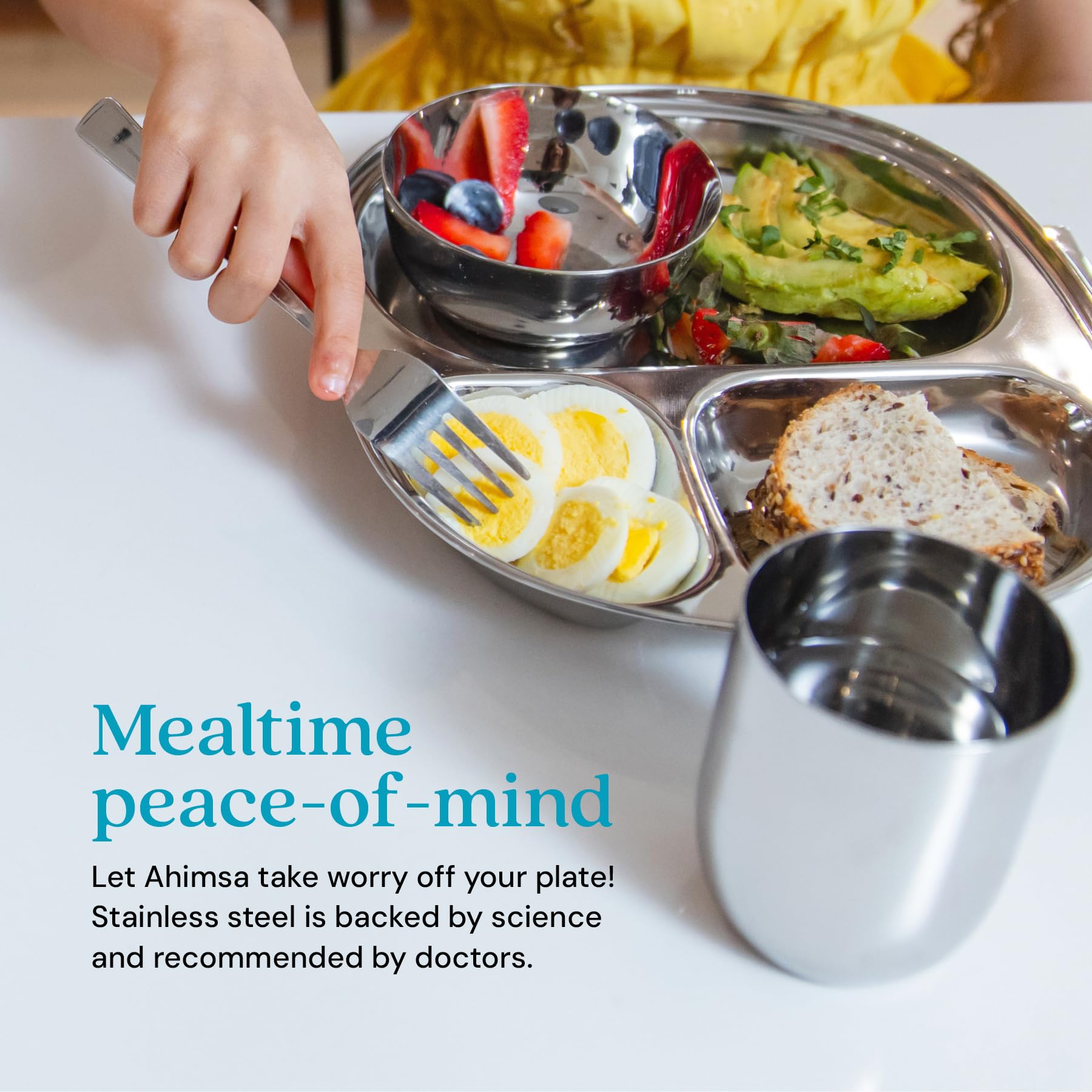 Ahimsa training cup in stainless steel promotes confident self-feeding during meals.