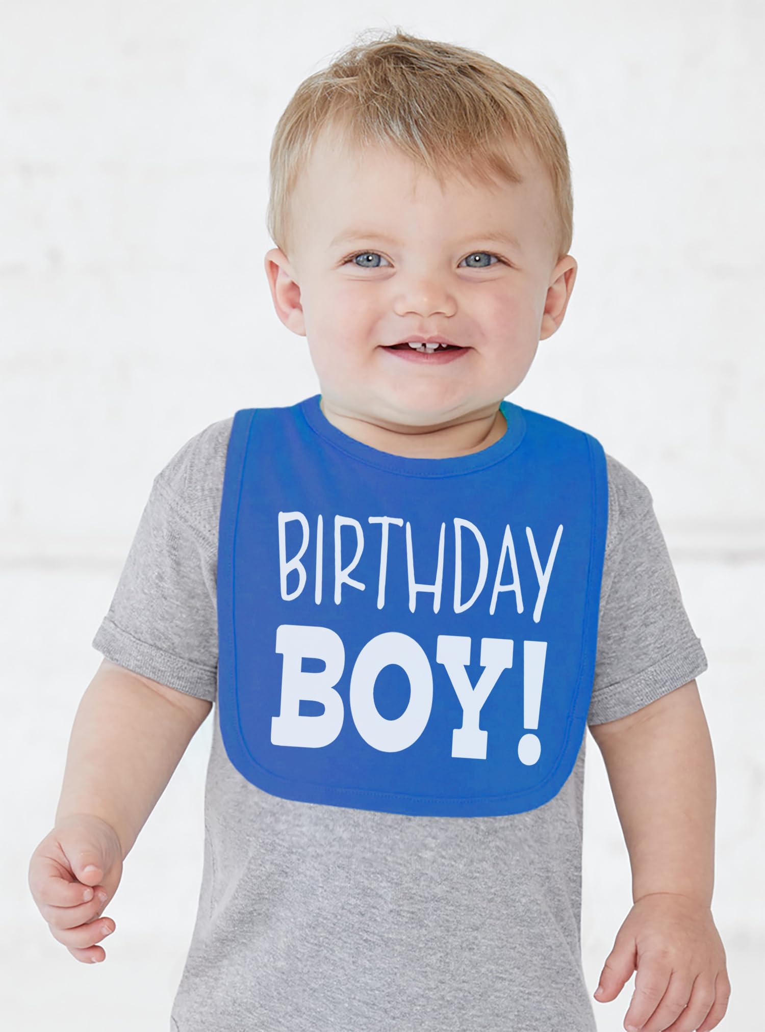 Aiden's Corner Royal smash cake bib worn with secure Velcro offers easy cleanup.