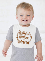 Aiden's Corner bib with festive fall leaves, bright and seasonal