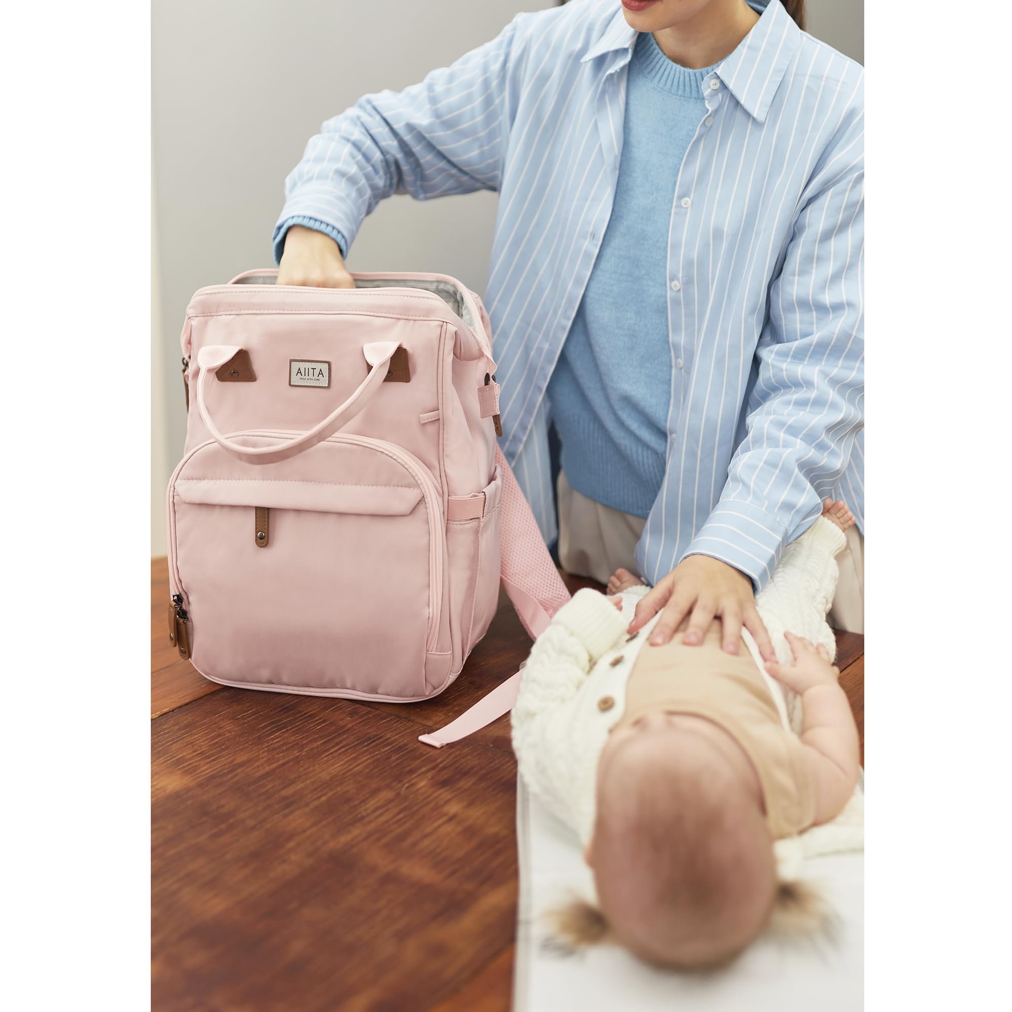 AIITA diaper bag backpack stroller attachment image illustrates easy travel with strollers.