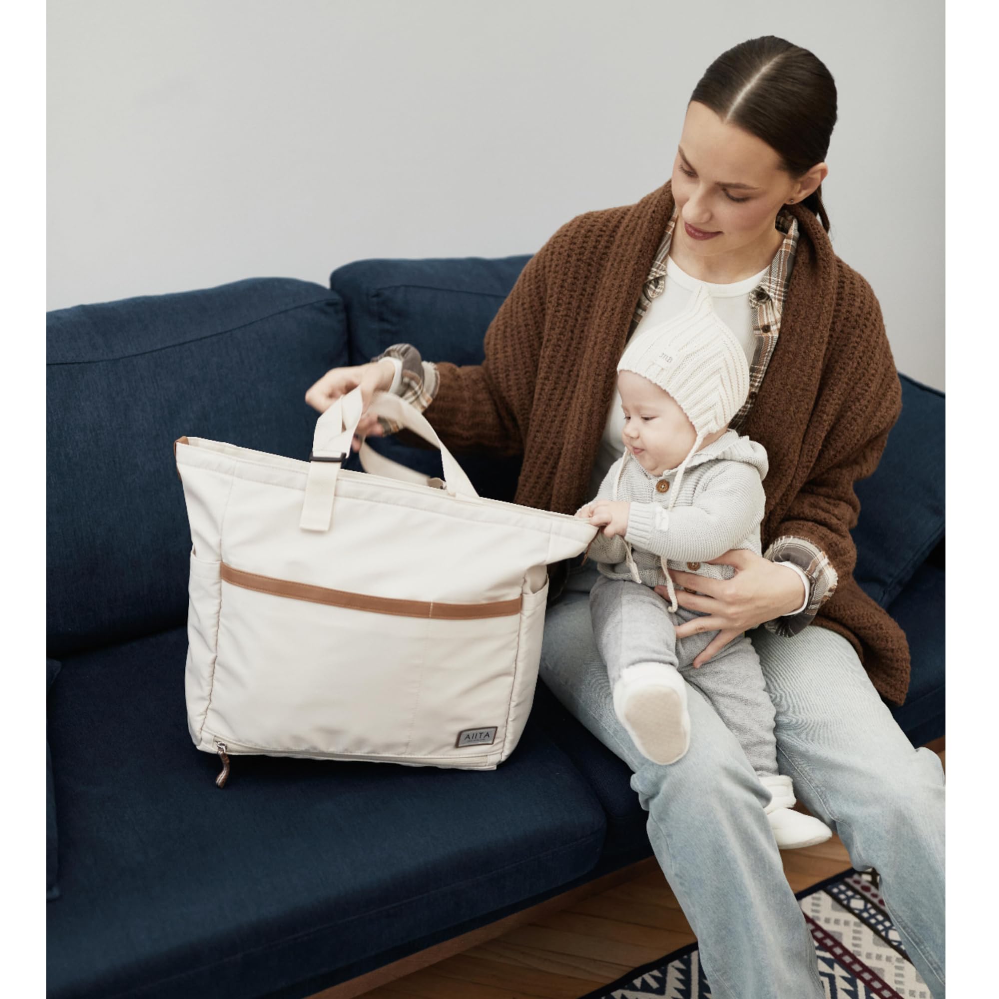 AIITA diaper bag tote includes portable changing pad.