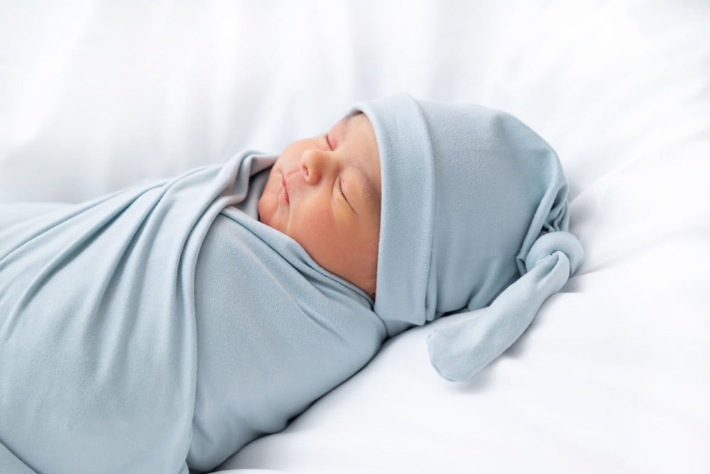 Aijoviko newborn swaddle blanket with hat set wrapped, showcasing soft fabric and cozy presentation.