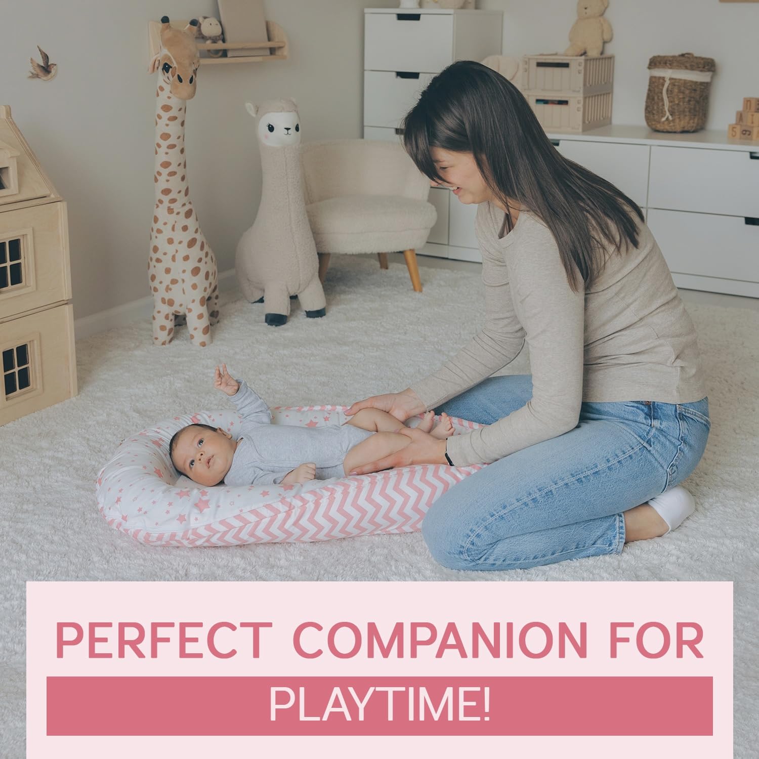 Aila+Aiden baby lounger pink in supervised use during diaper changes and bonding.