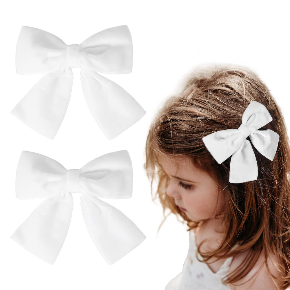 Aileam white velvet bow clip on girl's hair demonstrating secure clip