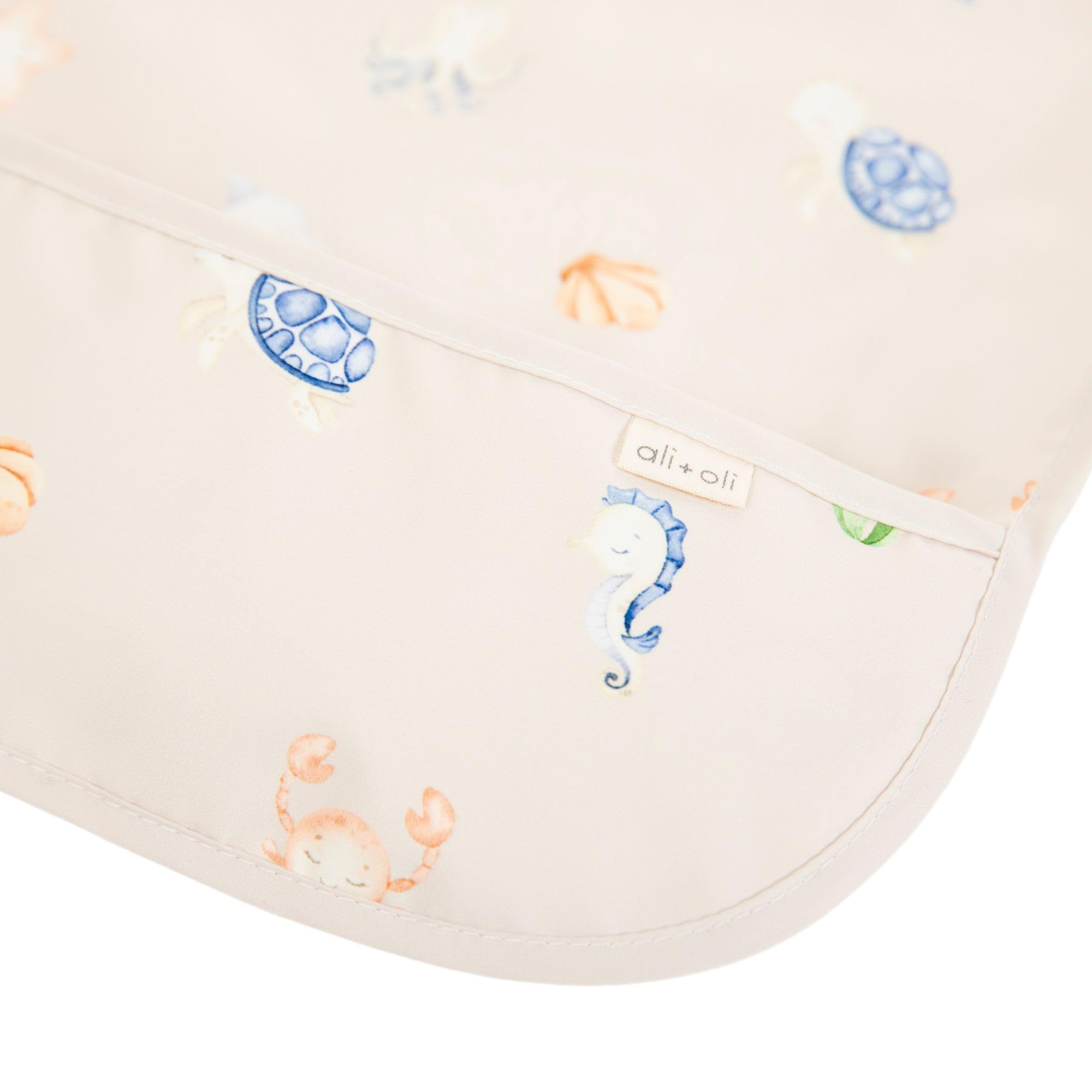 Ali+Oli Smock Bib Undersea long-sleeve side view shows adjustable fit for comfortable mealtimes.