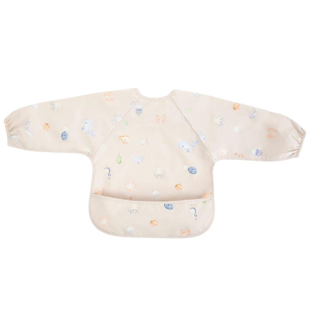 Ali+Oli Smock Bib Undersea long-sleeve worn image highlights soft neckline protecting baby skin.