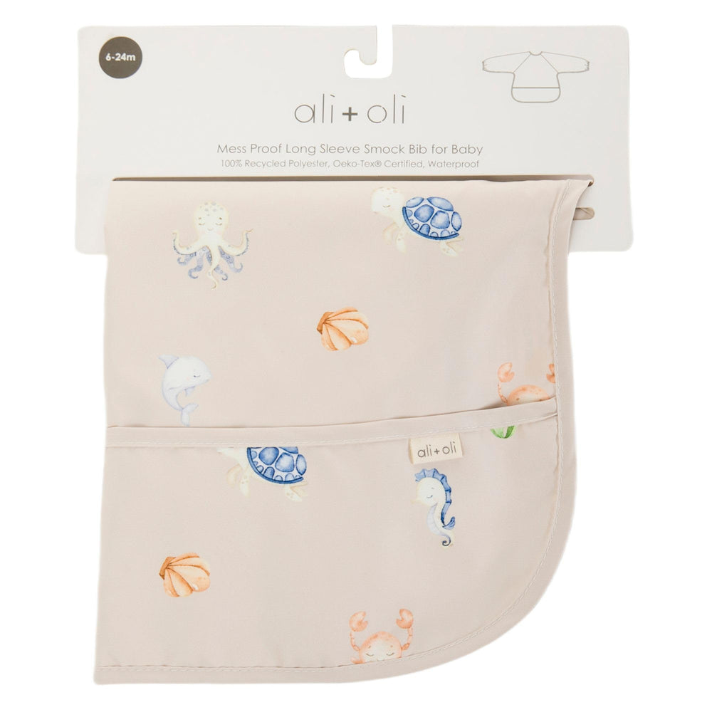 Ali+Oli Smock Bib Undersea machine washable label emphasizes easy care and durability.