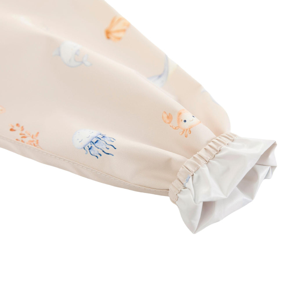 Ali+Oli Smock Bib Undersea pattern showcases modern nursery decor with Scandinavian colors.