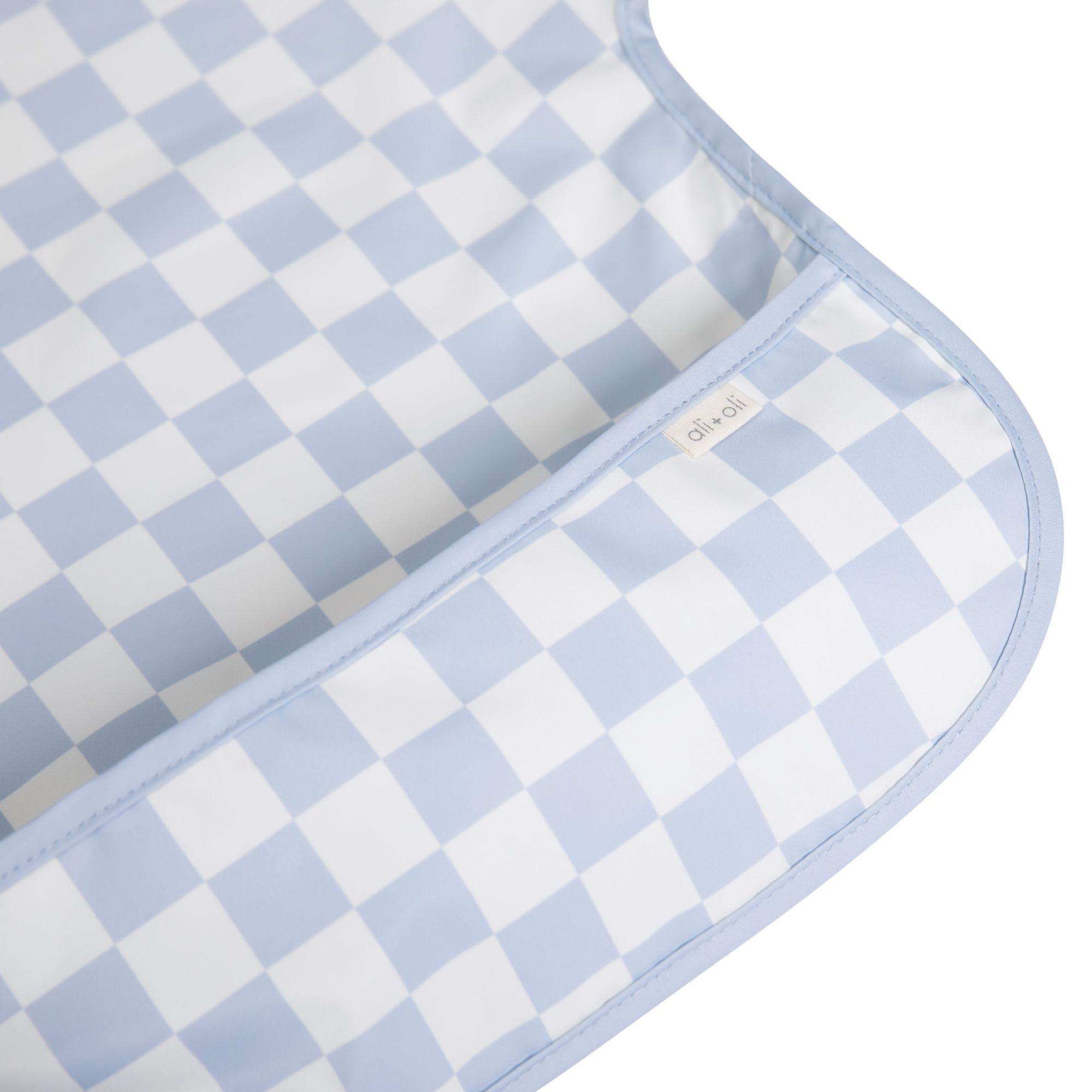 Ali+Oli Smock Bib waterproof coating close-up shows spill protection.