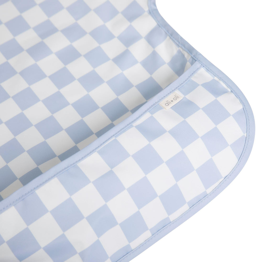 Ali+Oli Smock Bib waterproof coating close-up shows spill protection.