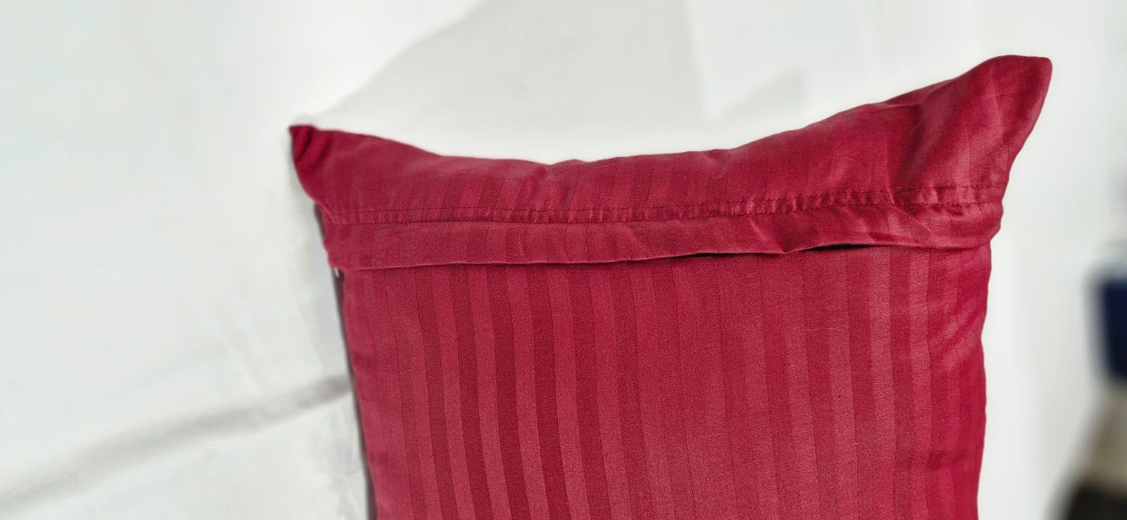 Ambition Home burgundy-striped pillowcase on toddler bed conveys cozy, stylish bedtime ambiance.
