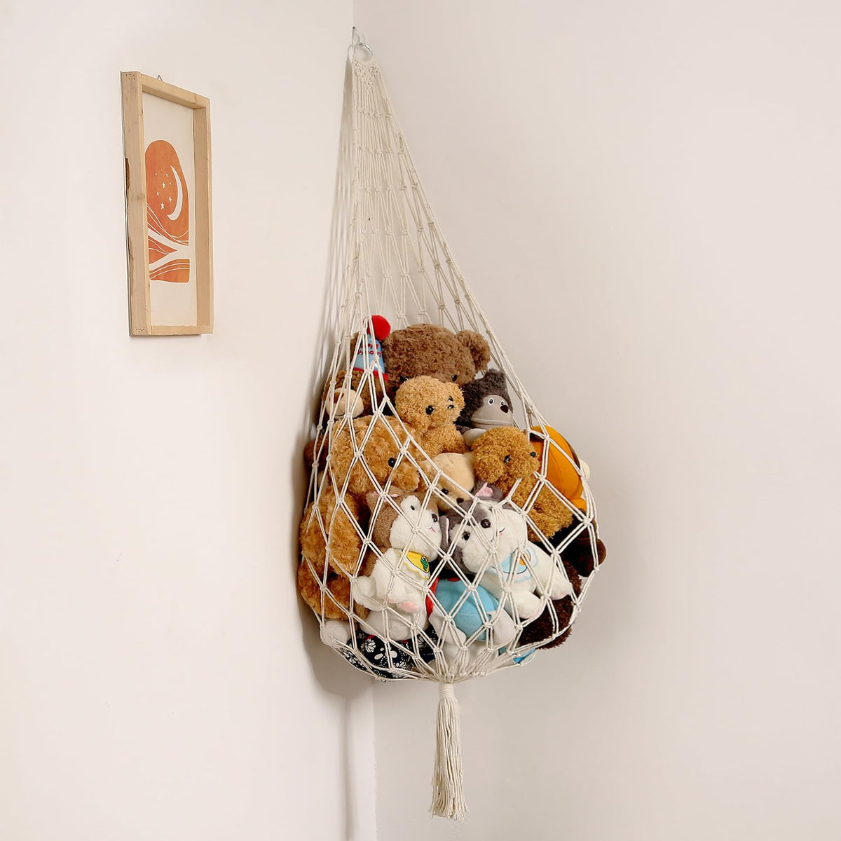 Amdermi stuffed animal storage hammock in cream hangs on wall, maximizing playroom space.