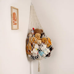 Amdermi stuffed animal storage hammock in cream hangs on wall, maximizing playroom space.