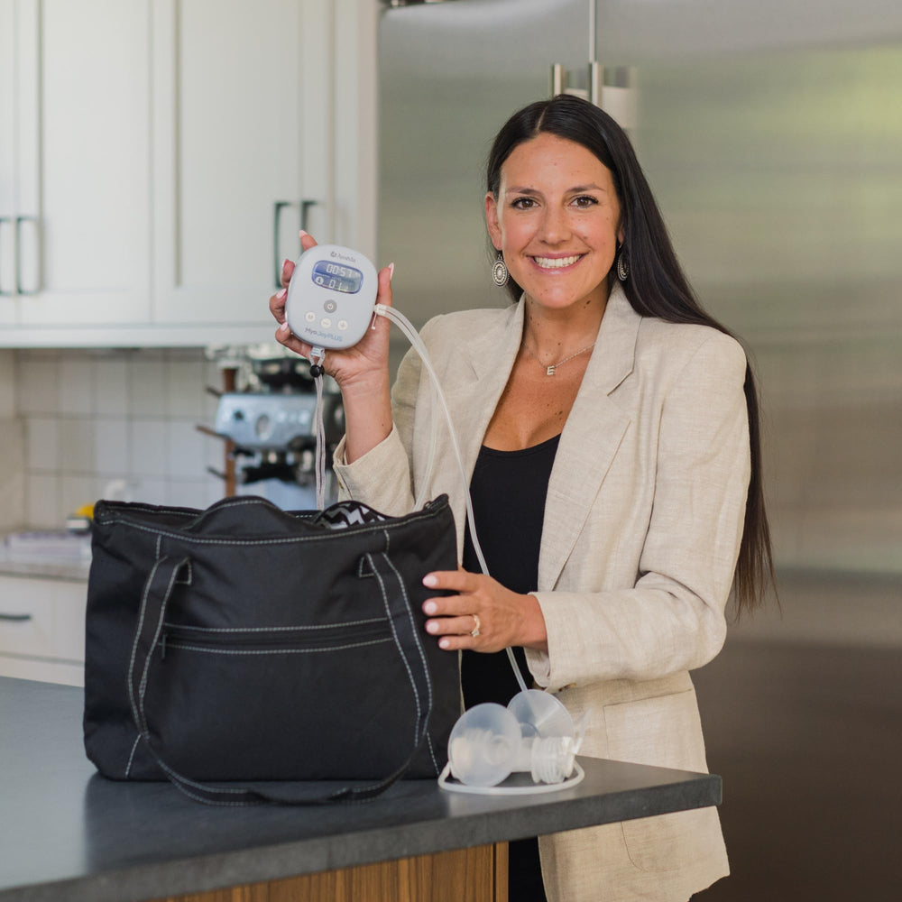 Ameda MYA Joy Plus wrist lanyard demonstrating hands-free pumping
