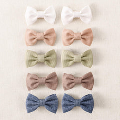 Amybasic 10pcs baby girl hair bow clip close-up showing gentle, non-slip grip for fine hair.