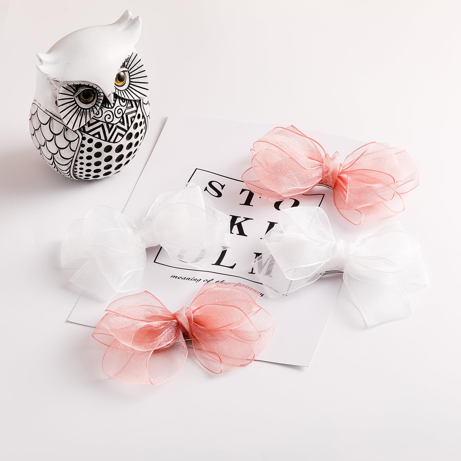 Amybasic pink organza bow close-up highlights sheer fabric and sheen