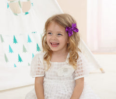 AMYDECOR alligator clip detail with smooth teeth keeps bows secure all day.