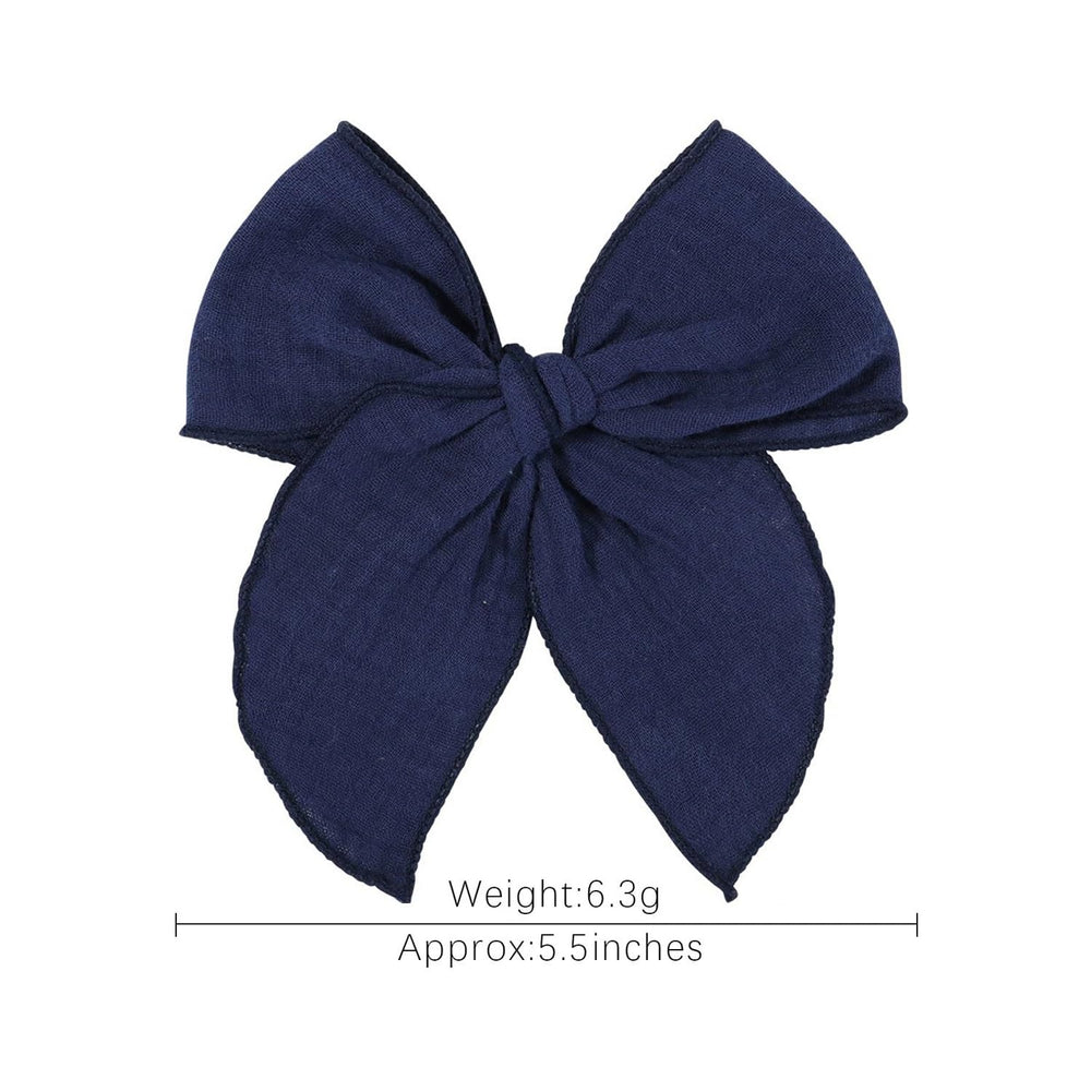 AMYDECOR navy blue Fable bow styled with baby outfits for special occasions.