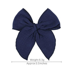 AMYDECOR navy blue Fable bow styled with baby outfits for special occasions.