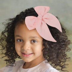 AMYDECOR pink fable bow side view with secure alligator clip for daily wear.