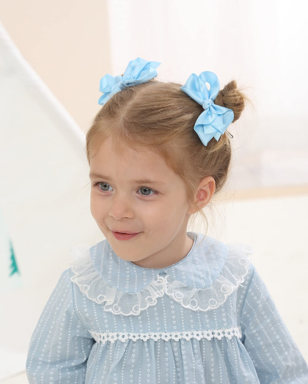AMYDECOR satin bow sky blue on hair shows easy attachment and secure hold.